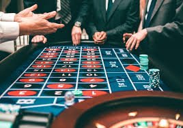 Live casino dealer interacting in a dark-themed studio with neon accents